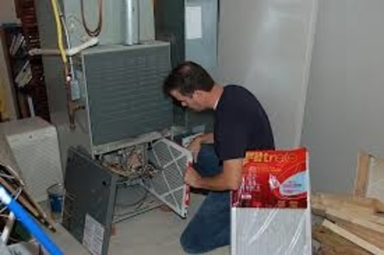 Man replacing furnace filter